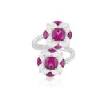 A RUBELLITE, RUBY AND DIAMOND DRESS RING Of crossover design, each cushion-shaped rubellite