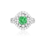 AN EMERALD AND DIAMOND RING The raised mount centring a square-shaped emerald weighing approximately