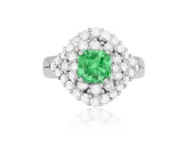 AN EMERALD AND DIAMOND RING The raised mount centring a square-shaped emerald weighing approximately