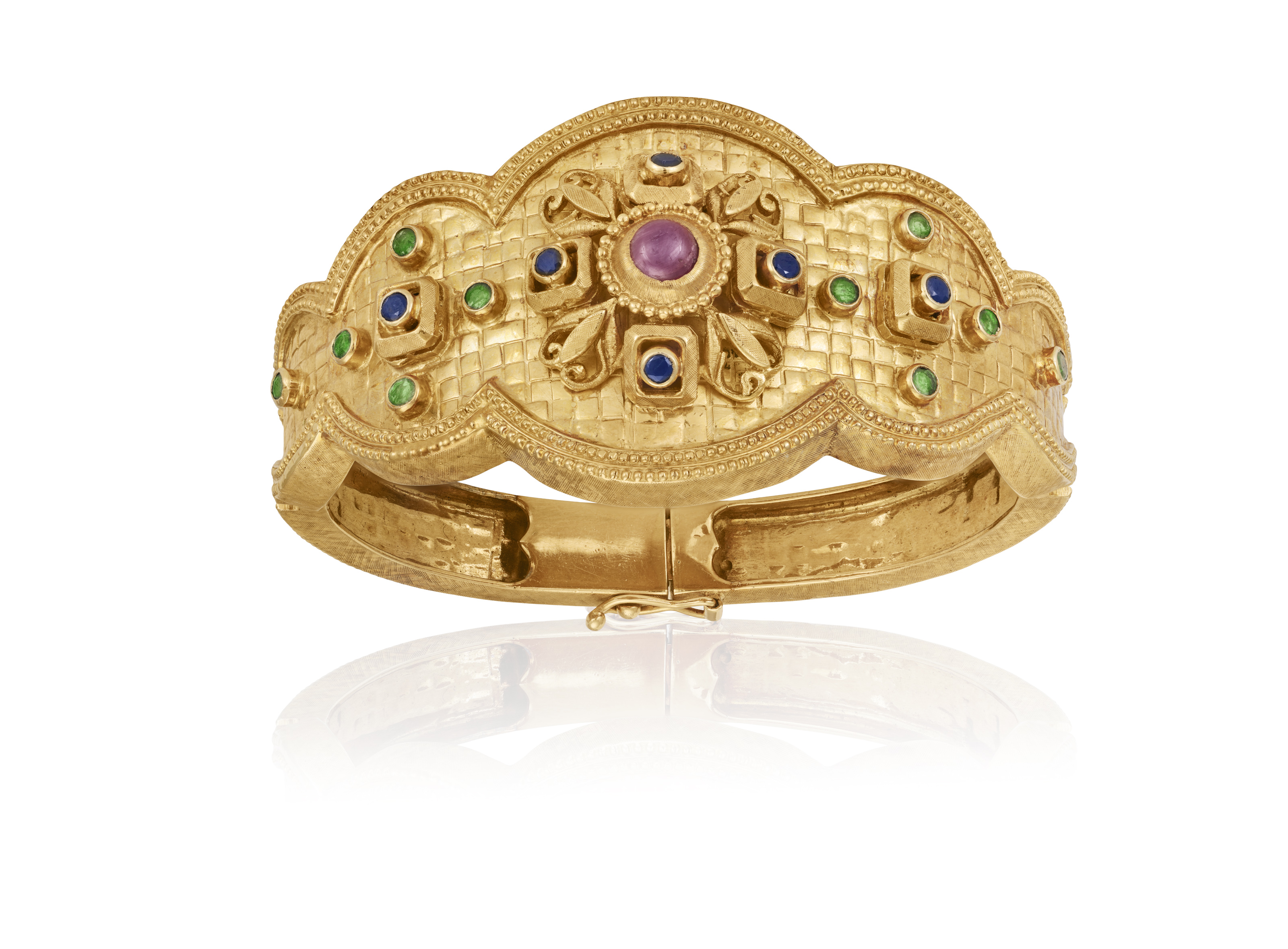 A GEM-SET BANGLE, BY ILIAS LALAOUNIS Of hinged design, the central scalloped plaque, centring a