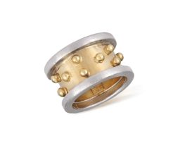 A GOLD AND SILVER RING, BY ZOLOTAS The bi-coloured thick band with beading detailing, mounted in 18K