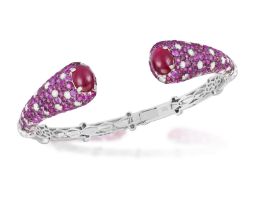 A RUBY AND DIAMOND BANGLE BRACELET Of opposing design, each terminal set with a cabochon ruby,