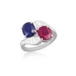 A RUBY, SAPPHIRE AND DIAMOND DRESS RING Of crossover design, set with an oval-shaped sapphire and