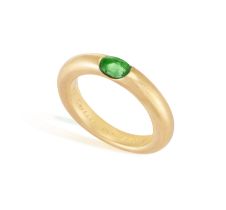 AN EMERALD 'ELLIPSE' RING, BY CARTIER, 1992 The oval-shaped emerald set to a plain hoop, mounted