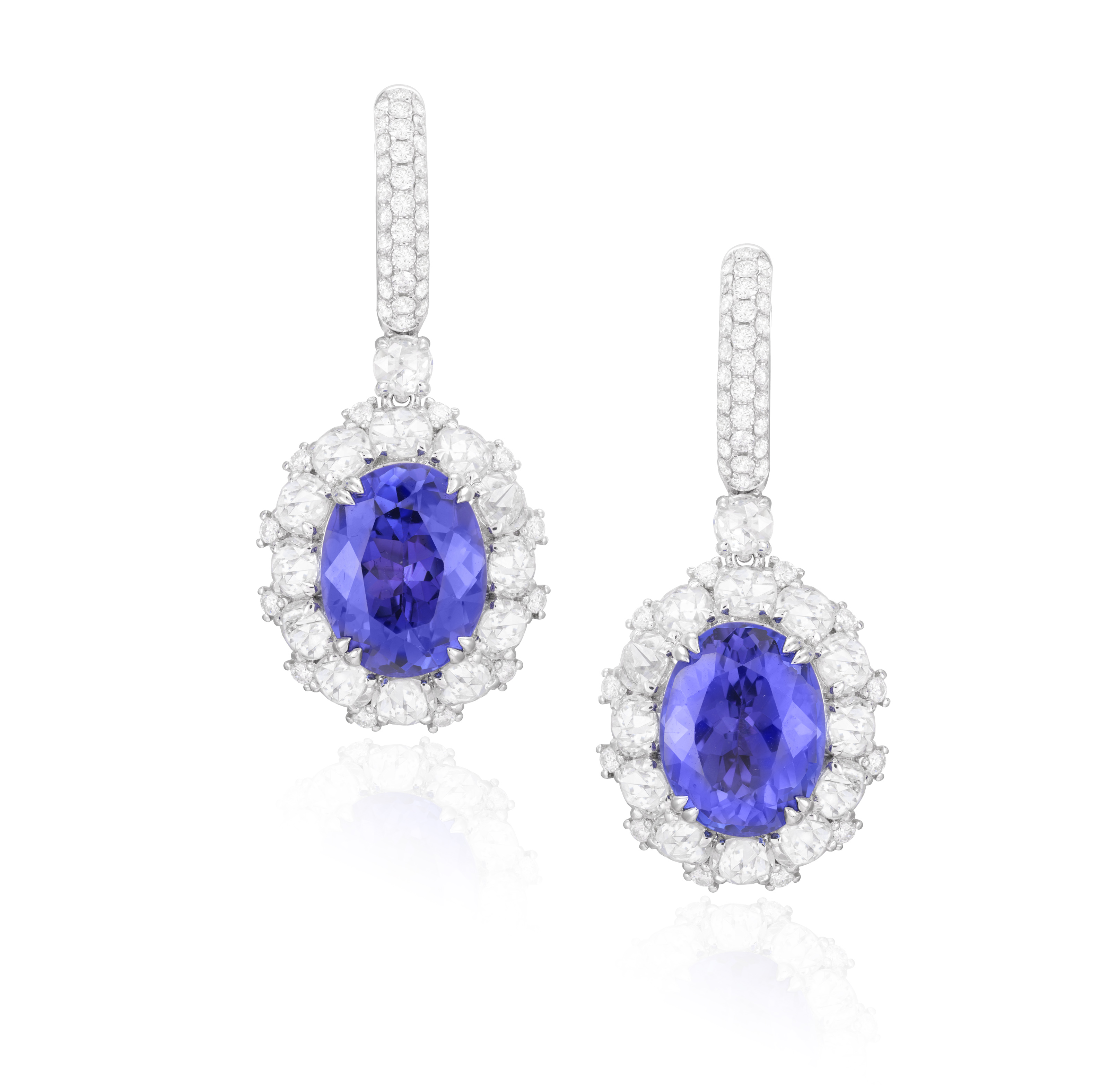 A PAIR OF TANZANITE AND DIAMOND PENDENT EARRINGS Each oval-shaped tanzanite weighing approximately