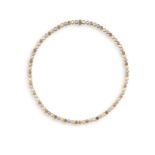 A DIAMOND LINE NECKLACE Composed of an articulated continuous line of brilliant-cut diamonds of