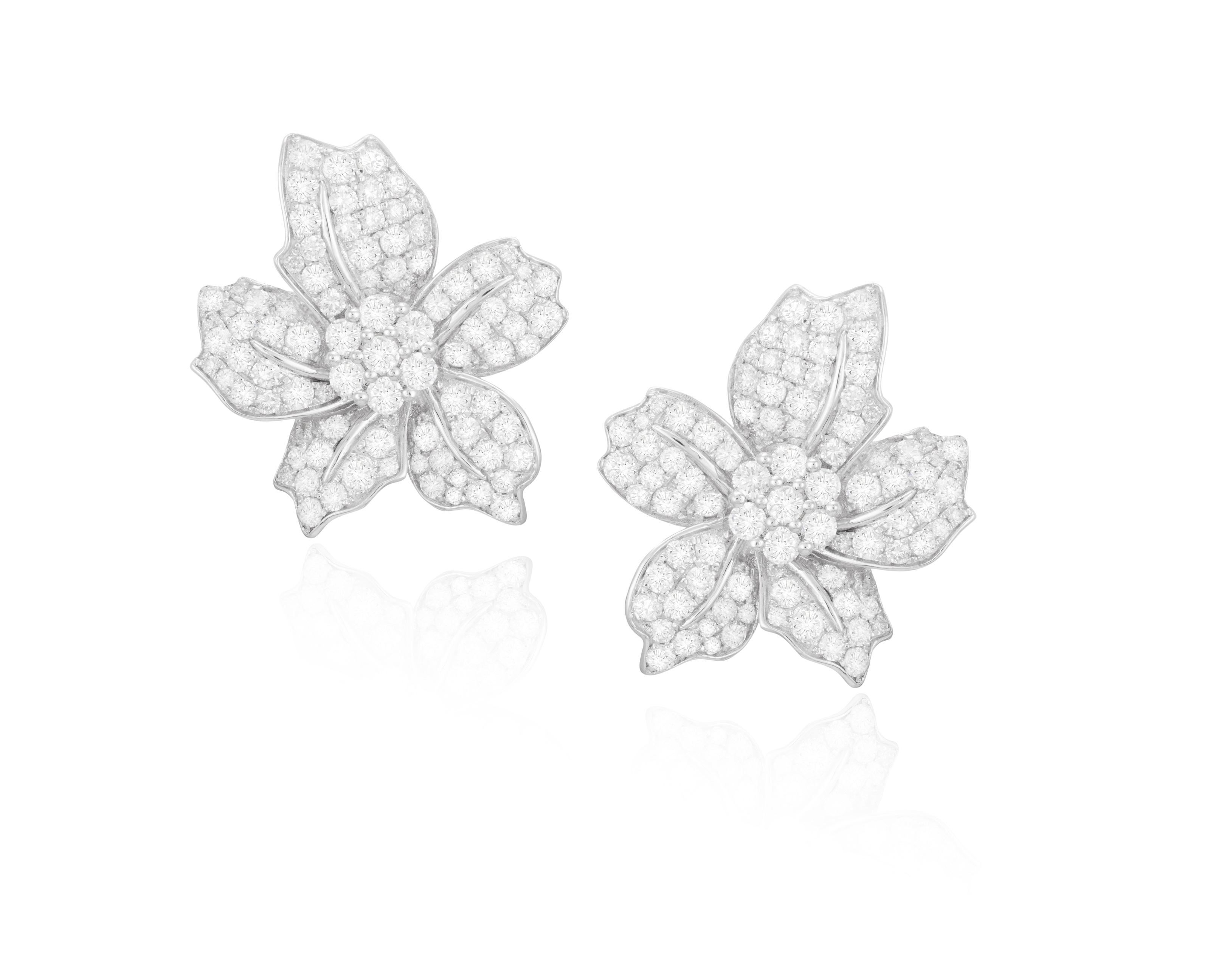 A PAIR OF DIAMOND EARRINGS Each flowerhead pavé-set with brilliant-cut diamonds, mounted in 18K