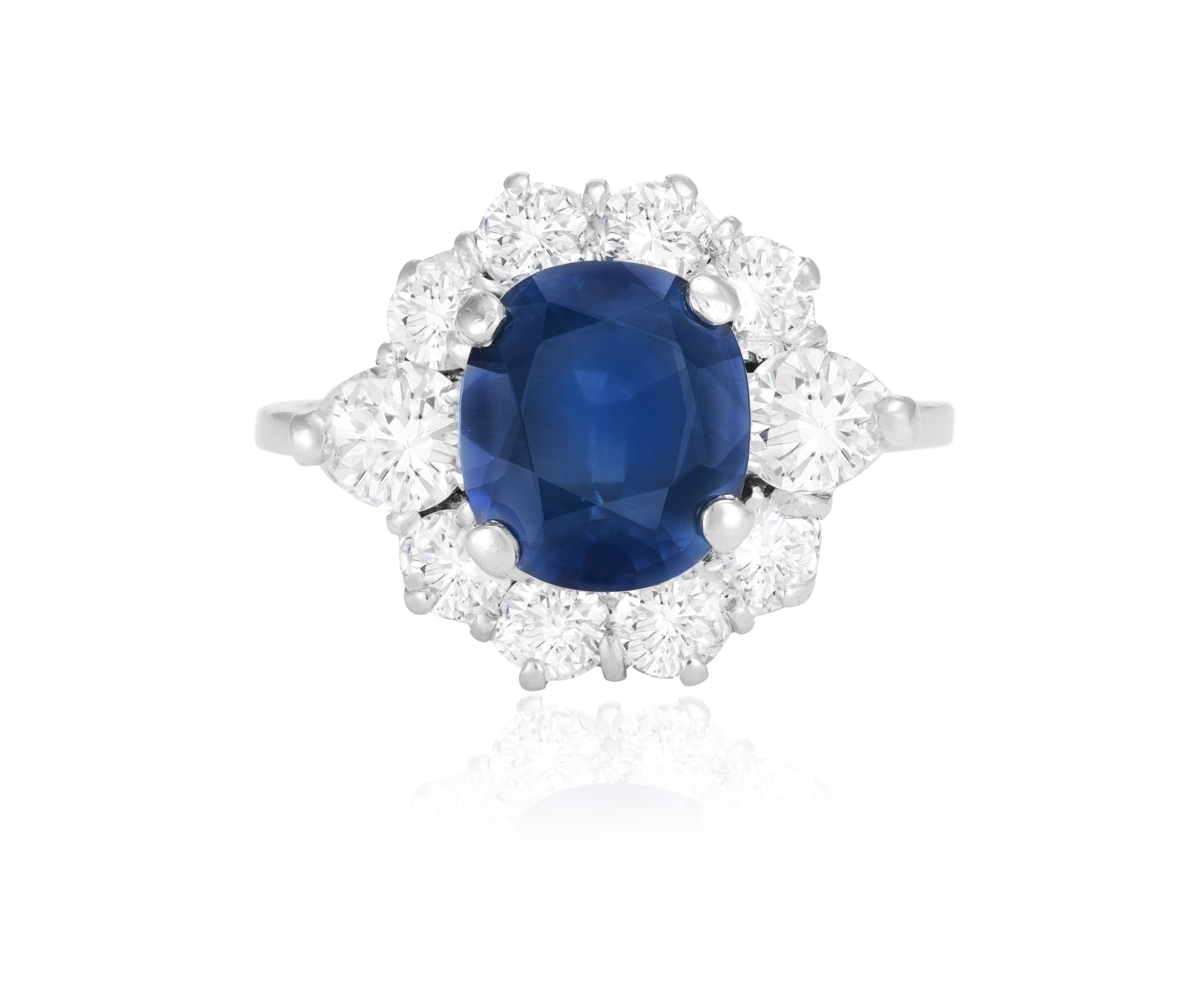 A SAPPHIRE AND DIAMOND CLUSTER RING The cushion-shaped sapphire weighing approximately 3.99cts,