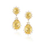 A PAIR OF SAPPHIRE AND DIAMOND PENDENT EARRINGS Each surmount set with an oval-shaped yellow