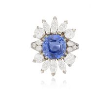 A SAPPHIRE AND DIAMOND CLUSTER RING The cushion-shaped sapphire weighing approximately 5.60cts,