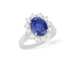 A SAPPHIRE AND DIAMOND CLUSTER RING The oval-shaped sapphire weighing approximately 3.00cts,