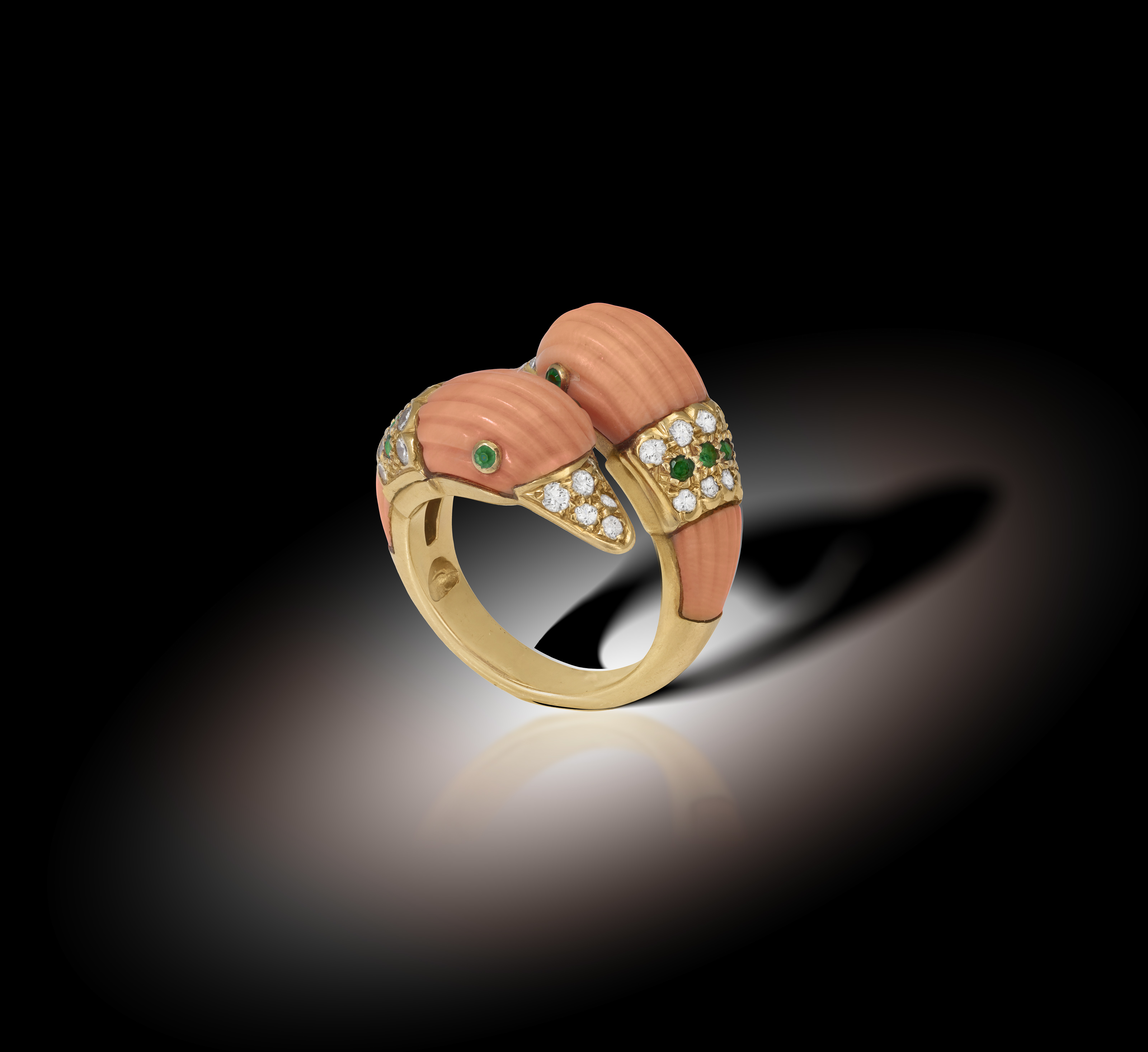 A COLLECTIBLE CORAL, EMERALD AND DIAMOND RING, BY VAN CLEEF & ARPELS, CIRCA 1970 Of cross-over