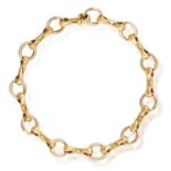 AN 18K GOLD BRACELET, BY CARTIER Composed of polished circular links and stylised baton-shaped