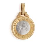 A GOLD ZODIAC PENDANT, BY BULGARI, CIRCA 1990 The circular concave pendant, the front side cast to