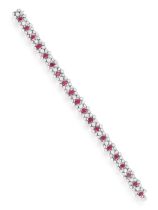 A RUBY AND DIAMOND BRACELET Set with a oval-shaped rubies, each within a brilliant-cut diamond