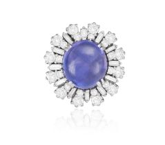 A SAPPHIRE AND DIAMOND CLUSTER RING, CIRCA 1960 The oval-shaped sapphire cabochon weighing