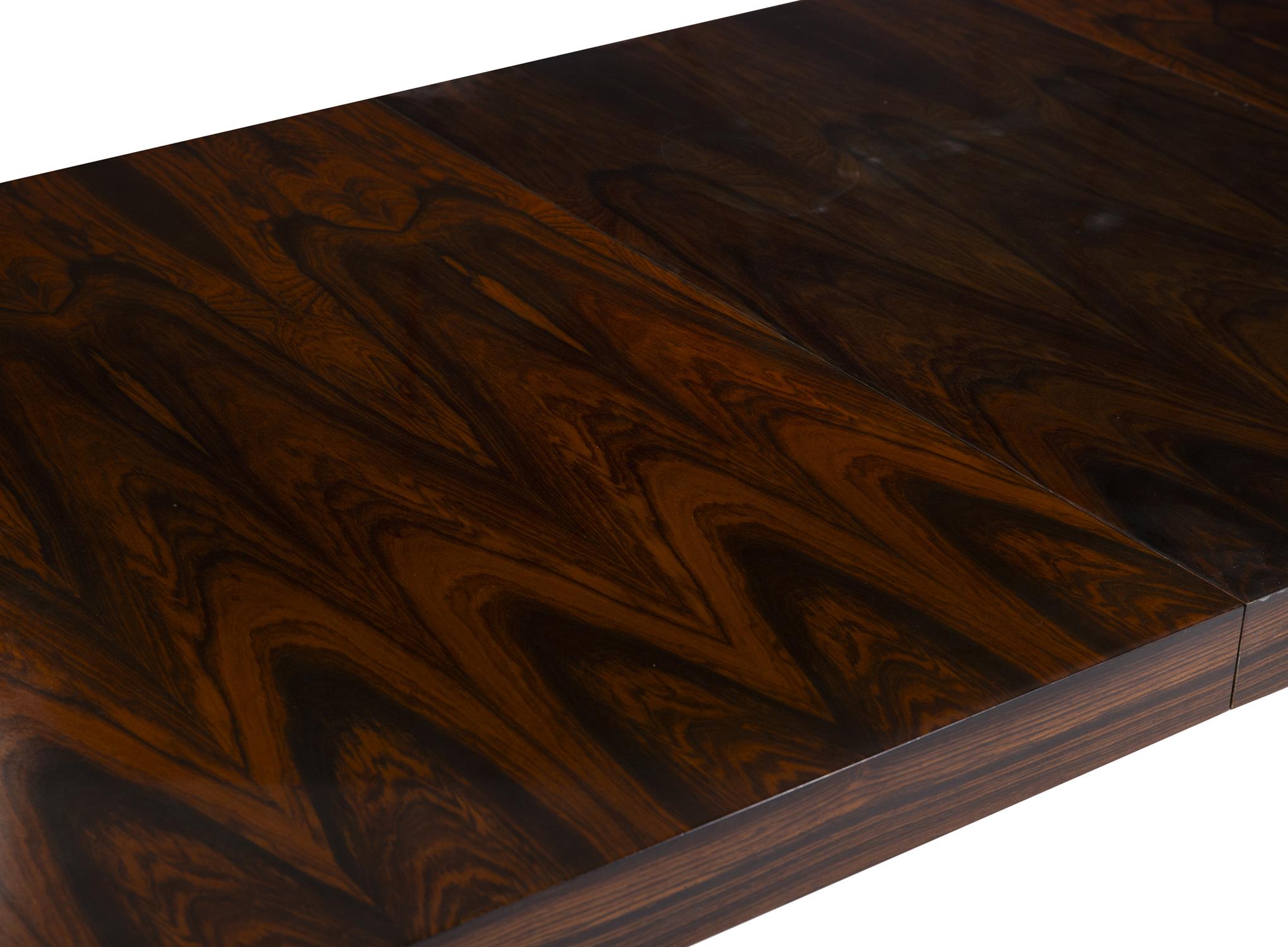 W.K. MOBEL A rosewood extending dining table by W.K. Mobel with hidden leaf with maker's label. - Image 5 of 6