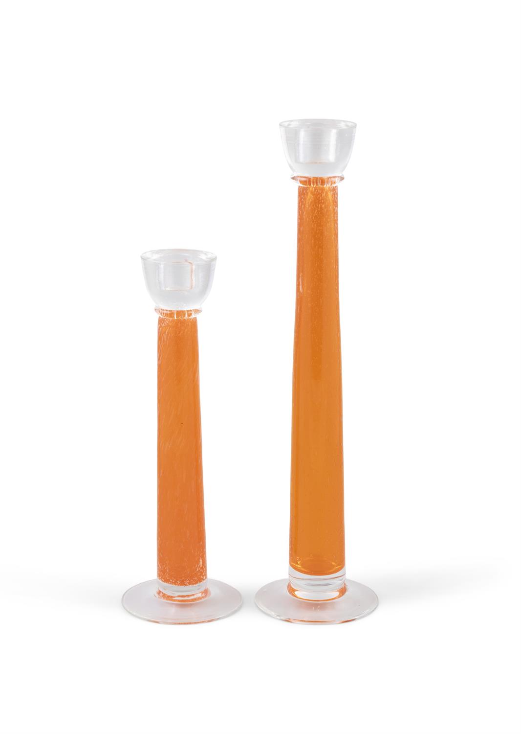 CANDLE STICKS A pair of orange and clear glass candle sticks of differing heights. Italy. 39.