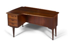DESK A teak boomerang desk with three drawers and one drop down door with maker's label. Sweden,