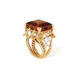 BOUCHERON: A CITRINE AND DIAMOND COCKTAIL RING, CIRCA 1960 The rectangular-cut smokey citrine