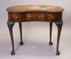 An early 20th century mahogany writing table inset tooled leather to the kidney-shaped top, fitted