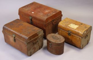 A set of three vintage grained tin graduated travelling trunks, 66.5cm, 54.5cm, & 45.5cm wide.