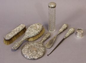 A matched silver-backed five-piece dressing table set; a cut-glass dressing table receptacle with