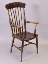 A comb-back elbow chair with a hard seat, & on four turned legs with spindle stretchers.