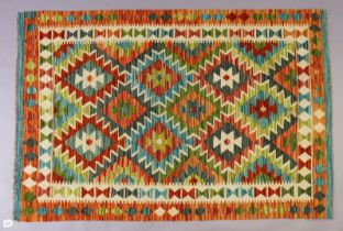 A Chobi Kilim rug of ochre ground with three rows of lozenges in multiple borders, 149cm x 99cm.