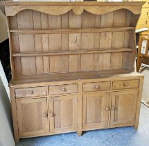 A beech kitchen dresser the upper part with two open shelves & having a paneled back, the base