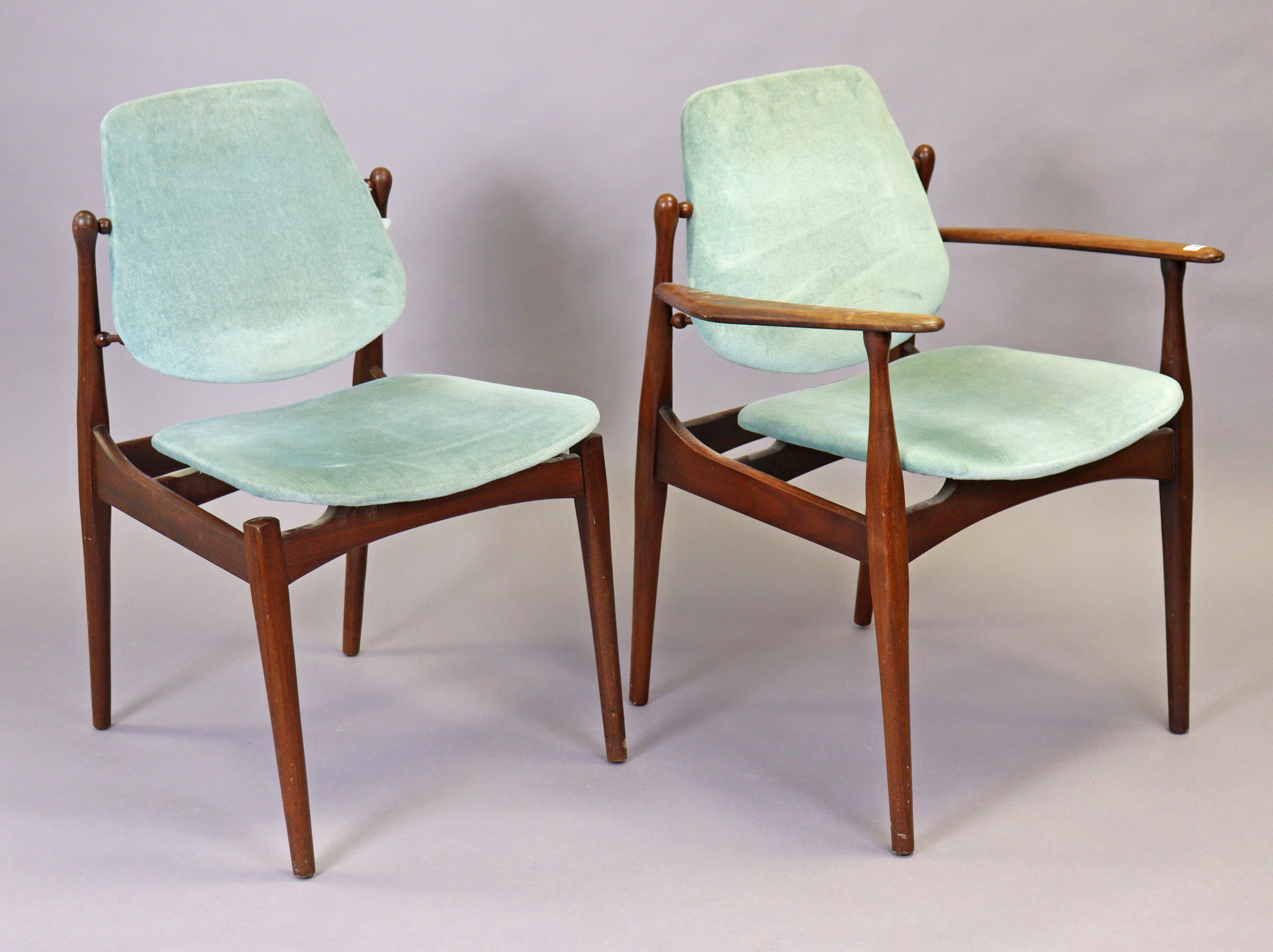 A mid-century teak carver chair having a padded seat & back upholstered blue velour, & on round tape