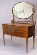 An Edwardian inlaid-mahogany bow-front dressing table with an oval swing mirror to the stage back