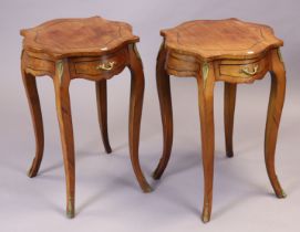 A pair of continental-style mahogany circular occasional tables each fitted with a frieze drawer,