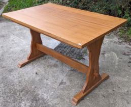 An elm kitchen table with a rectangular top, & on shaped end supports joined by a plain centre