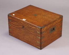 An oak & brass-mounted canteen fitted four removable trays enclosed by a hinged lift-lid, bears