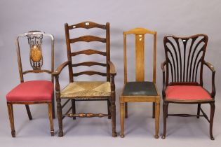 An oak ladder-back carved chair with a woven-rush seat, & on turned legs with a carved spindle front