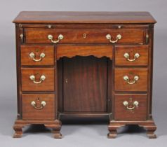 An 18th century mahogany kneehole desk, fitted with a brushing slide and arrangement of eight