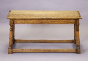 A late 19th/early 20th century oak small bench with hard seat, on turned tapering legs with plain