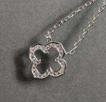 A quatre-foil pendant set numerous cubic zirconia, on silver fine-link chain necklace.