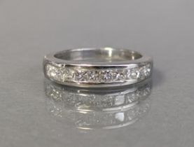 A diamond half-hoop ring set row of princess-cut diamonds (total weight 1 carat) to an 18ct white