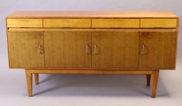 A Gordon Russell of Broadway long teak sideboard enclosed by two pairs of panel doors with four