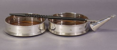 A pair of Elizabeth II silver wine coasters with beaded rims & plain straight sides, inset turned