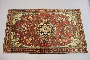 A northwest Persian Sarouk Mahal rug of rust ground with a central medallion surrounded by floral