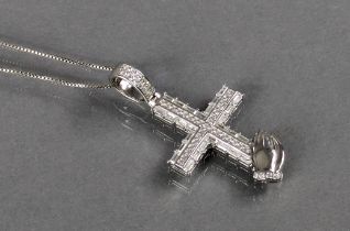 A silver pendant in the form of a crucifix & hands-in-prayer, set numerous small cubic zirconia,