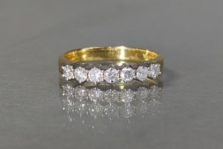 An 18ct gold ring set row of seven round-cut diamonds, total weight 0.5 carat, 3.7g, size N/O,