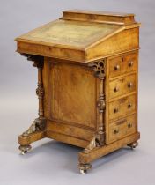 A Victorian inlaid walnut davenport with interior enclosed by a sloping hinged lid with gilt-