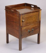 A Georgian mahogany bedside commode with pierced handles to the tray-top, enclosed by a panel door