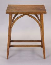 An arts & crafts oak rectangular occasional table with shaped supports, on square legs with plain