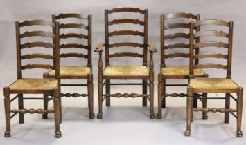 A set of five early/mid-20th century oak ladder-back dining chairs with rush seats and turned