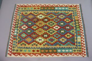 A Turkish Anatolian kelim rug of ivory ground with repeating multicoloured geometric design